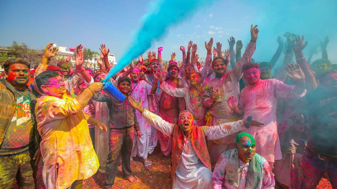 “People celebrating Holi festival with colors and traditional rituals in Gopeshwar, Uttarakhand