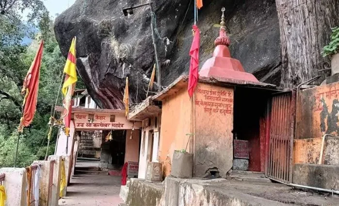 Kalpeshwar Temple cave shrine in Urgam Valley surrounded by lush green mountains during Panch Kedar Yatra