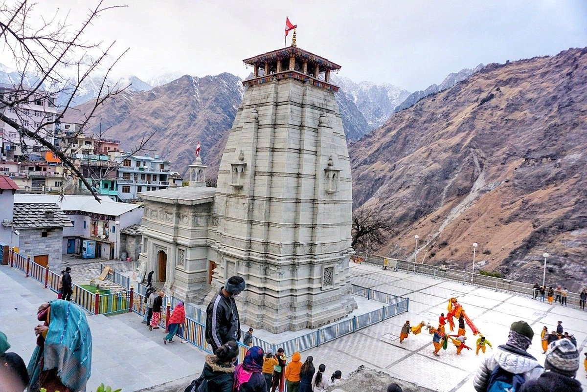 Scenic view of Narsingh Temple in Joshimath with traditional architecture and snow-capped peaks in the background