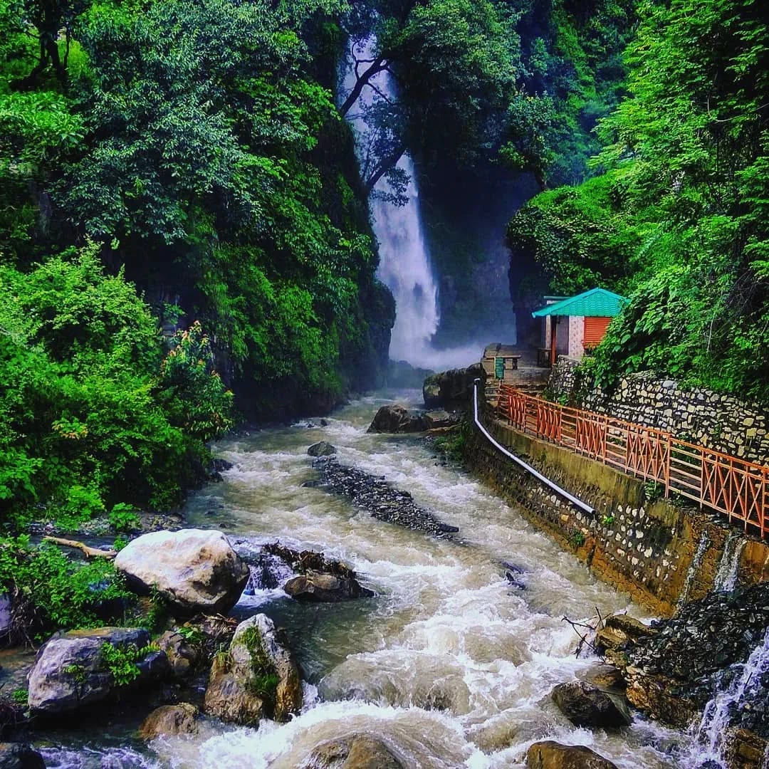 Scenic Tiger Waterfall in Chakrata with cascading water, forested cliffs, and natural trekking path