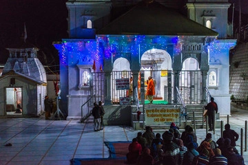 Gangotri Temple nestled in the Himalayas with devotees and flowing Ganga River